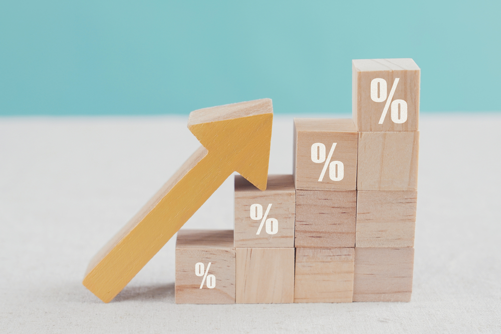 an image of blocks with percentage signs and an upwards-facing arrow to denote a story about annual house price growth